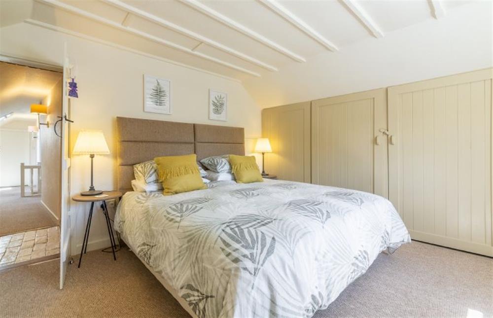 First floor:  Master bedroom with built-in wardrobe at Swift Cottage, Dersingham near Kings Lynn