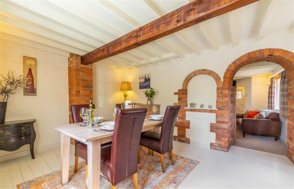 Ground floor:  Dining room with arched doorway to sitting room at Swift Cottage, Dersingham near Kings Lynn