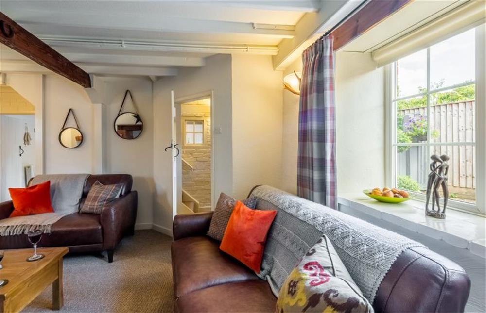 Ground floor:  Sitting room with comfy leather sofas at Swift Cottage, Dersingham near Kings Lynn