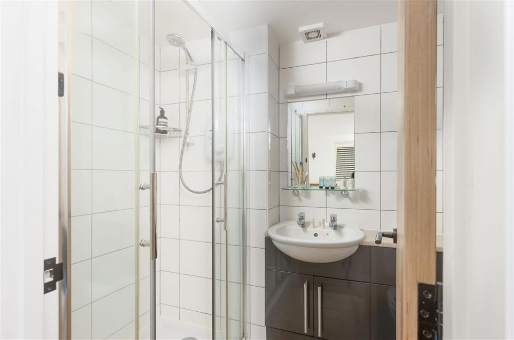 En-suite with a shower cubicle, wash basin and WC