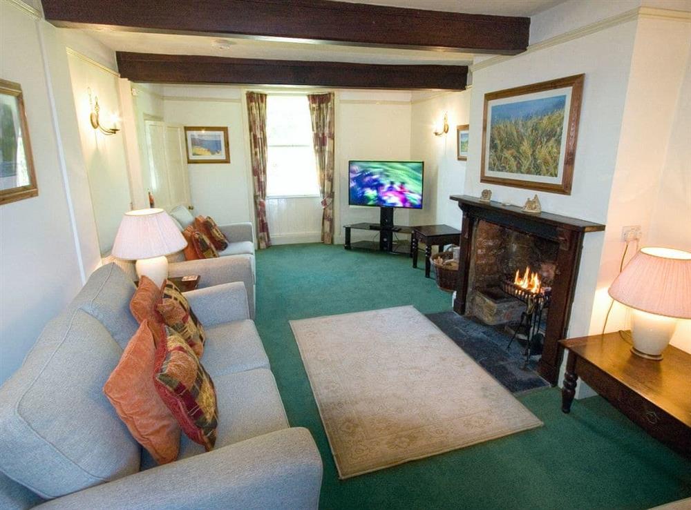 Charming living room with beams at Swiss Cottage in Chideock, Nr Bridport, Dorset., Great Britain