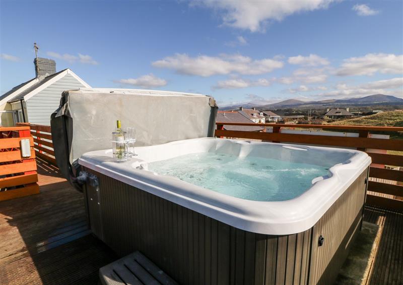 Relax in the hot tub at Swn Y Mor, Dinas Dinlle
