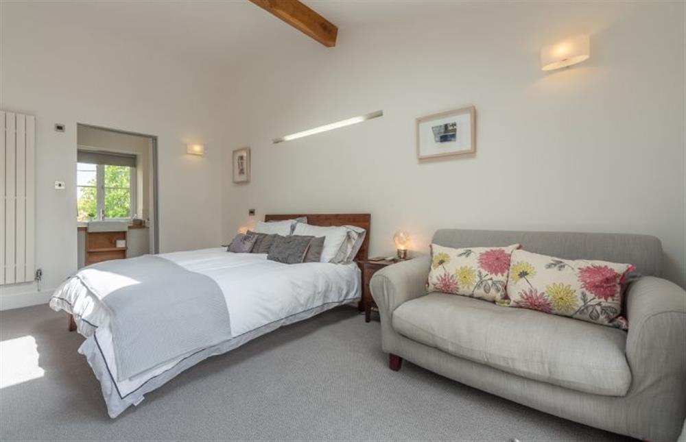 First floor:  Master bedroom with comfy sofa (photo 2) at Sybil Cottage, Holme-next-the-Sea near Hunstanton