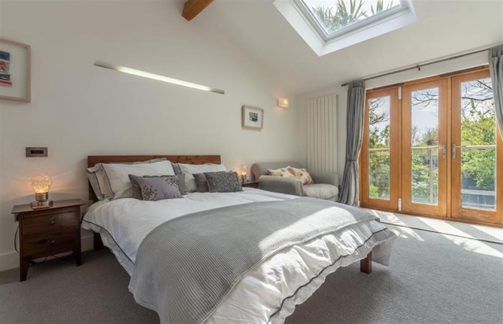 First floor:  Master suite with glass doors to balcony overlooking the gardens (photo 2) at Sybil Cottage, Holme-next-the-Sea near Hunstanton