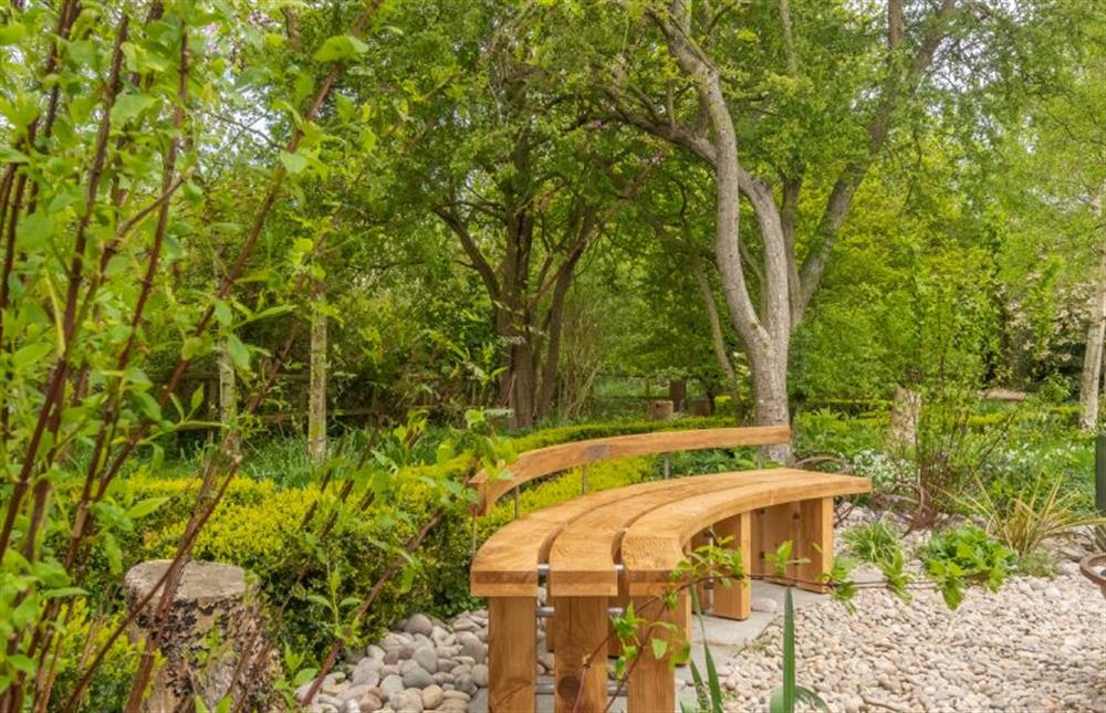 Gardens:  With feature wooden bench seating (photo 2) at Sybil Cottage, Holme-next-the-Sea near Hunstanton