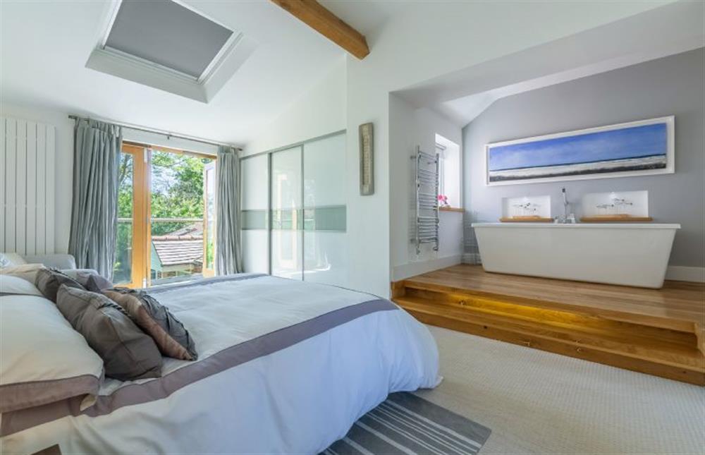 Sybil Cottage: Stylish master suite with balcony overlooking the acre of gardens at Sybil Cottage, Holme-next-the-Sea near Hunstanton