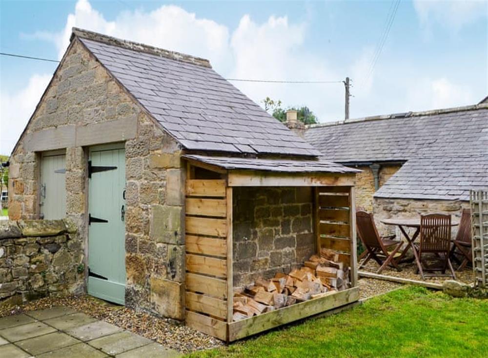 Enclosed sitting-out area with garden furniture and BBQ at Sycamore Cottage in Barrasford, near Hexham, Northumberland