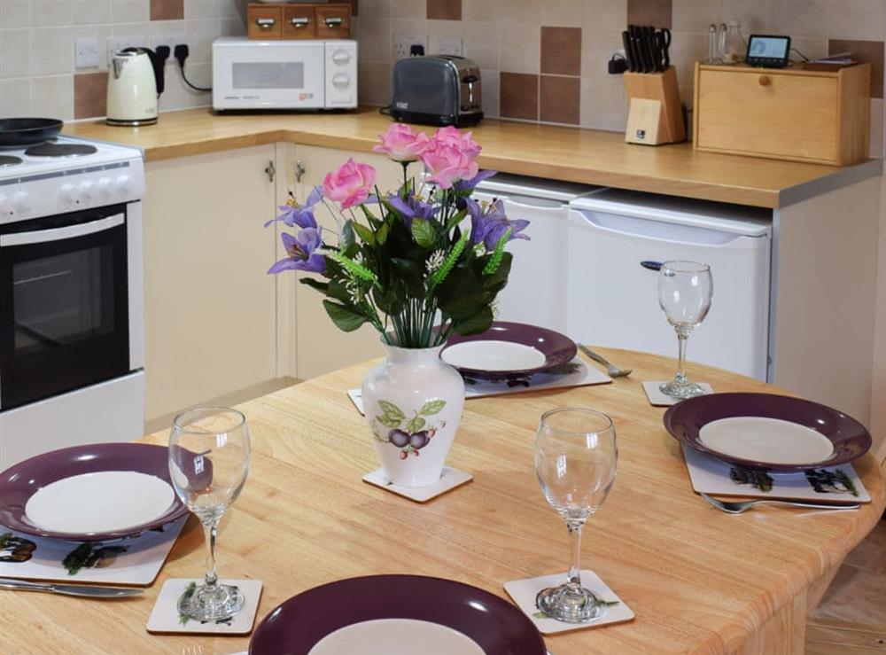 Dining table comfortable set for four guests at Sycamore Cottage in Borrowby, near Staithes, North Yorkshire