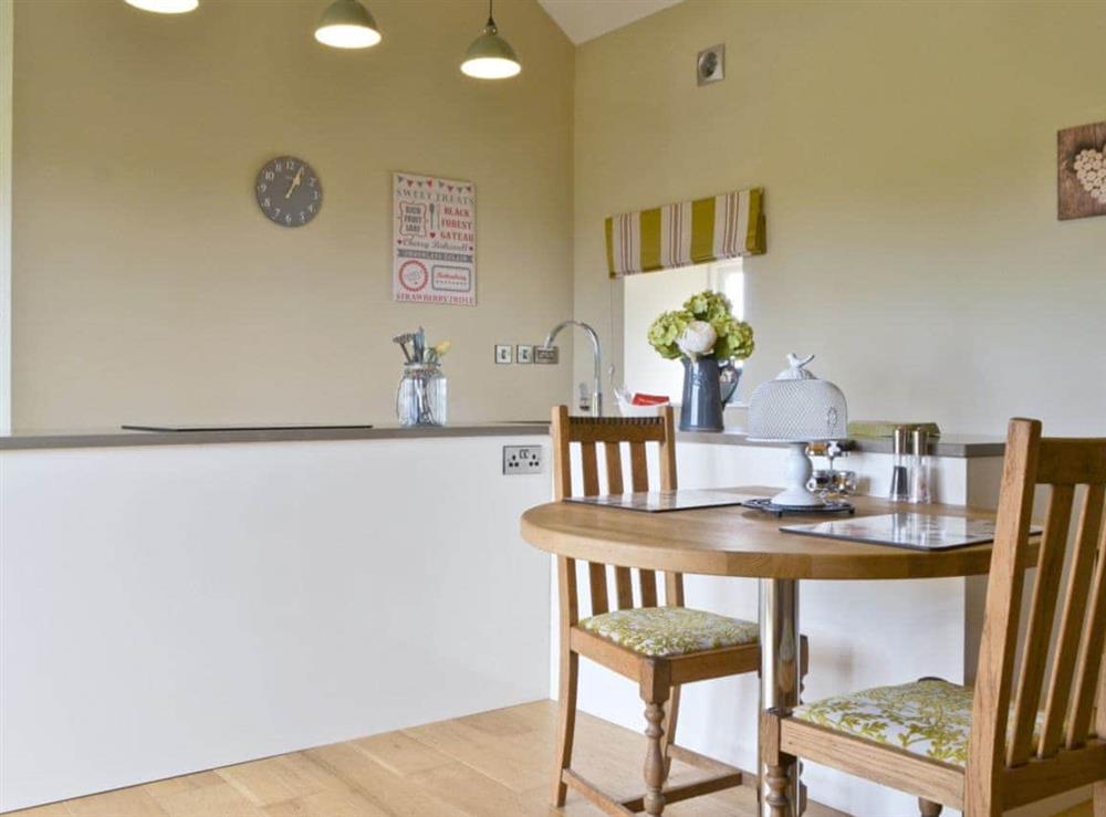 Sleek kitchen with convenient dining area at Sykelands Cottage in Dalton near Richmond, North Yorkshire