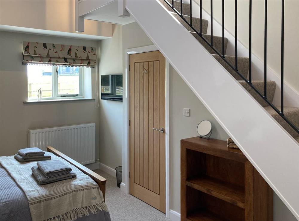 Double bedroom with access stairs to mezzanine (photo 2) at Tadpole Mews at Frog Hall in Tilston, Cheshire