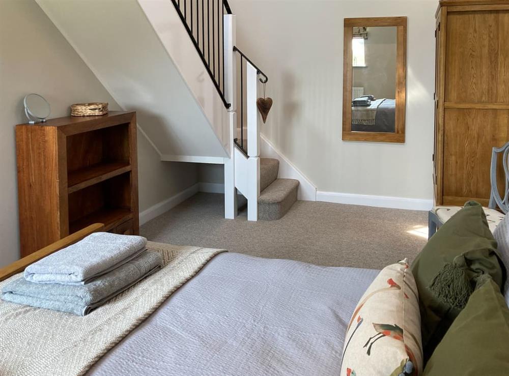 Double bedroom with access stairs to mezzanine at Tadpole Mews at Frog Hall in Tilston, Cheshire