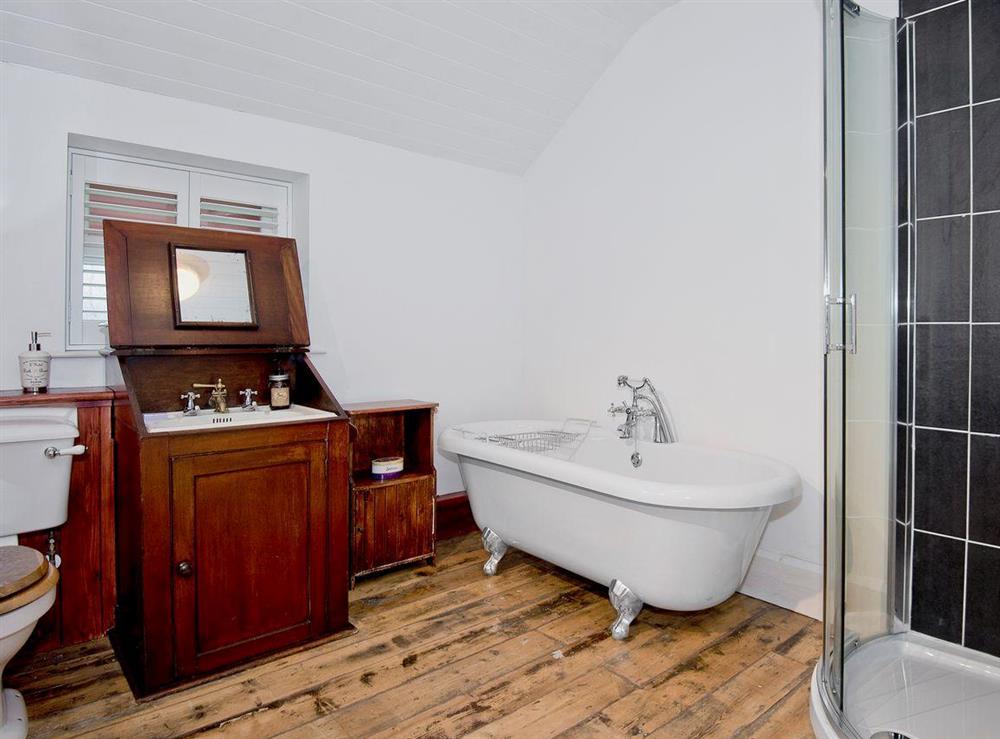 Beautiful bathroom with a mix of modern and traditional elements at Tŷ Cai, 