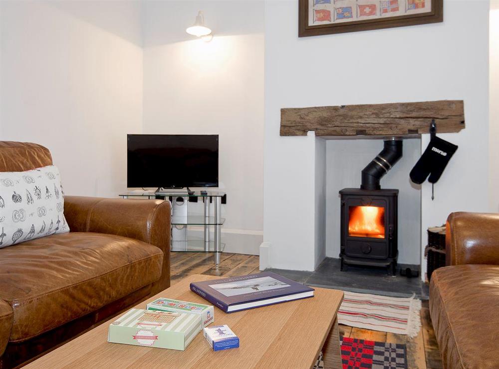 Spacious comfortable living room with wood burning stove at Tŷ Cai, 