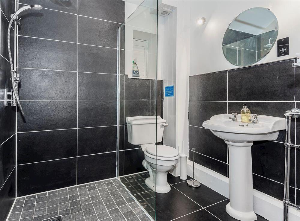 Luxurious bathroom with wet room style walk in shower at Tŷ Macsen, 
