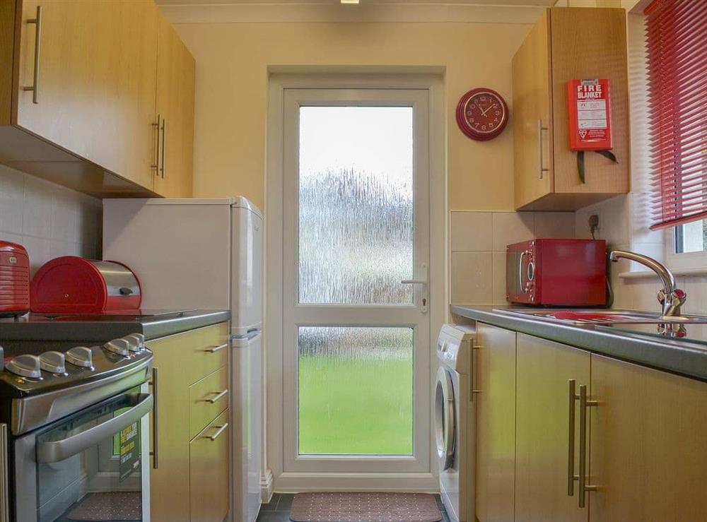 Galley style kitchen with garden access at Talland Bay in Liskeard, Cornwall