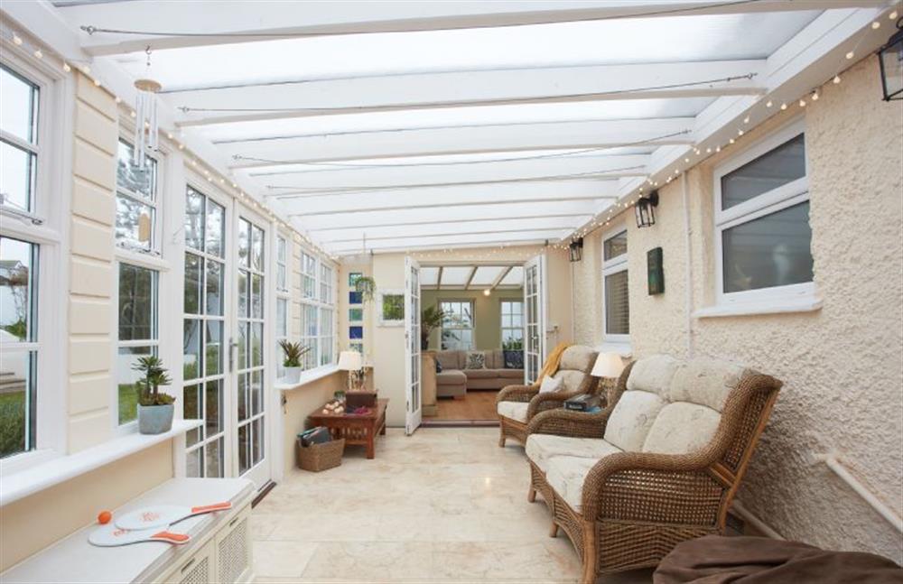 Tamarisk House, Cornwall: Conservatory looking out to the garden at Tamarisk House, Newquay