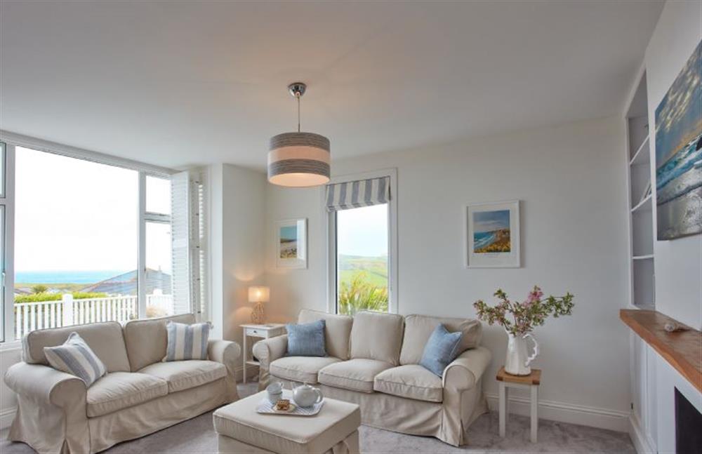 Tamarisk House, Cornwall: Sitting room with large comfy sofas, sea views, a Smart television and wood burning stove