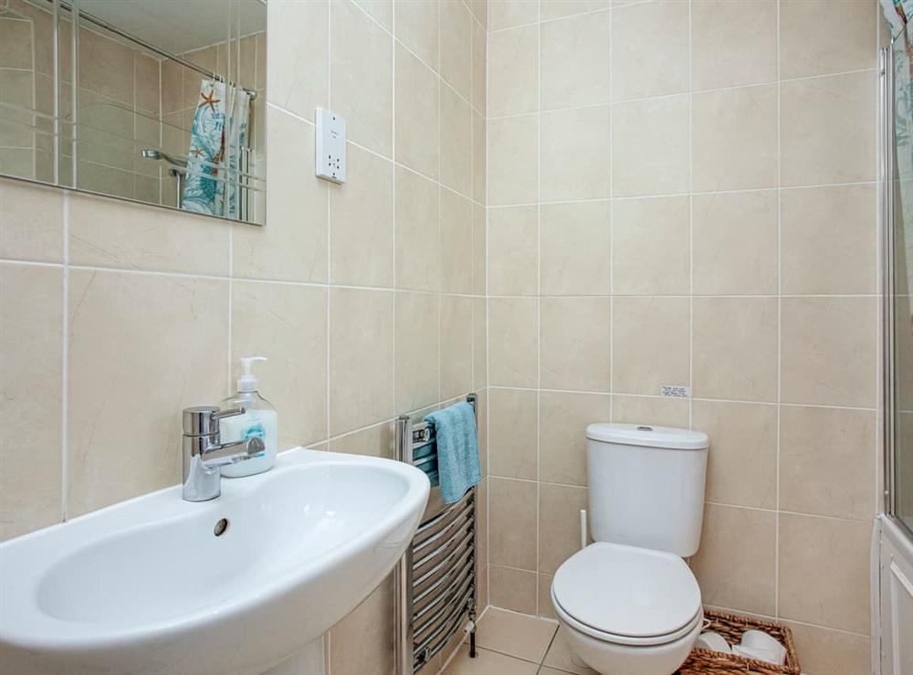 Fully tiled modern bathroom at Tamarisk in Torquay, Devon
