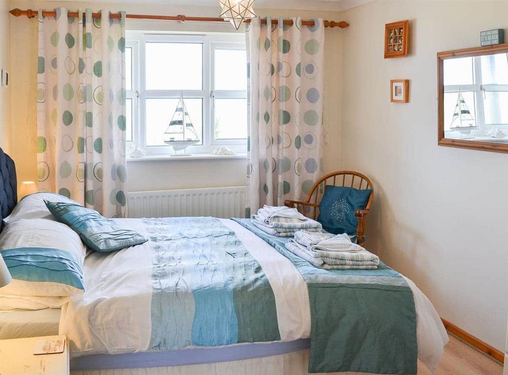 Warm and welcoming double bedroom at Tamarisk in Walcott, Norfolk
