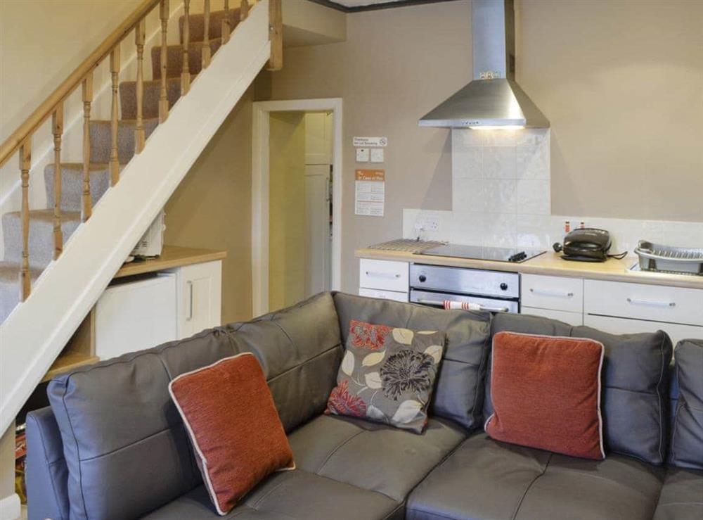 Comfy seating in living area and stairs to upper level at Tan y Bryn in Prenteg, near Porthmadog, Gwynedd