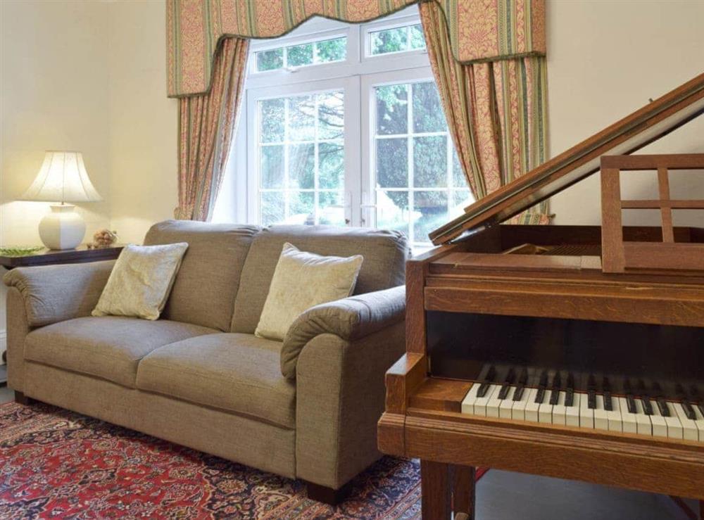 Furnishings in the living room include a grand piano at Tan Y Castell in Llanmill, near Narberth, Dyfed