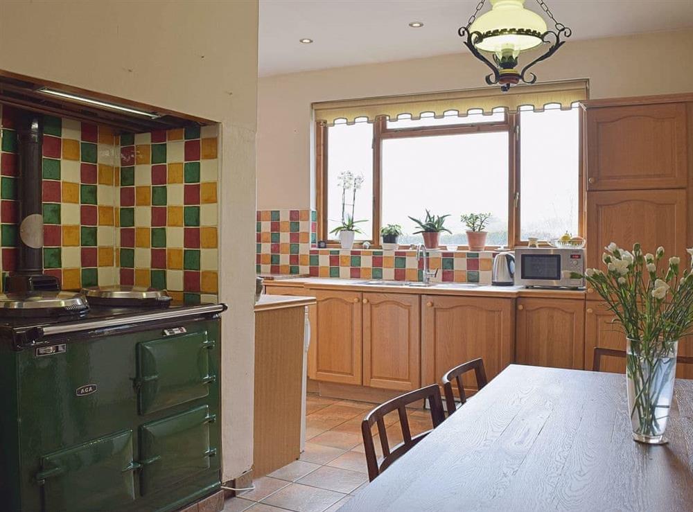 The tile-floored kitchen diner has an Aga as well as a breakfast area at Tan Y Castell in Llanmill, near Narberth, Dyfed