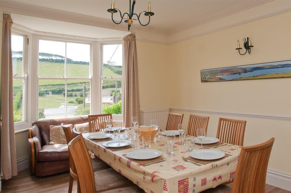 Dining area with bay window and sofa at Tarqua in Hope Cove, Nr Kingsbridge