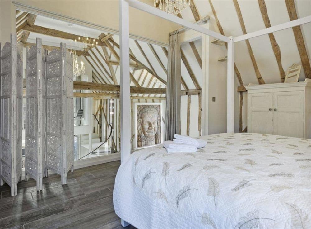Luxurious gallery style four Poster bedroom (photo 2) at Tatters Barn in Coggeshall, near Braintree, Essex