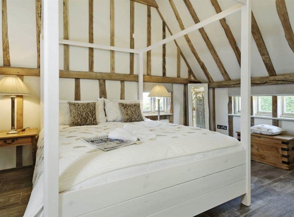 Luxurious gallery style four Poster bedroom at Tatters Barn in Coggeshall, near Braintree, Essex