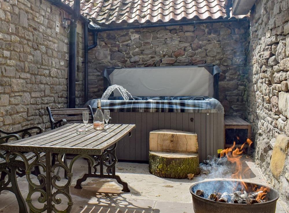 Excellent patio area with relaxing hot tub at Tavern Cottage, 