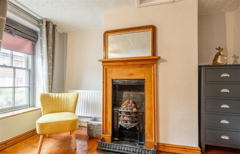 First floor: Feature fireplace in the master bedroom at Teacup Cottage, Syderstone near Kings Lynn