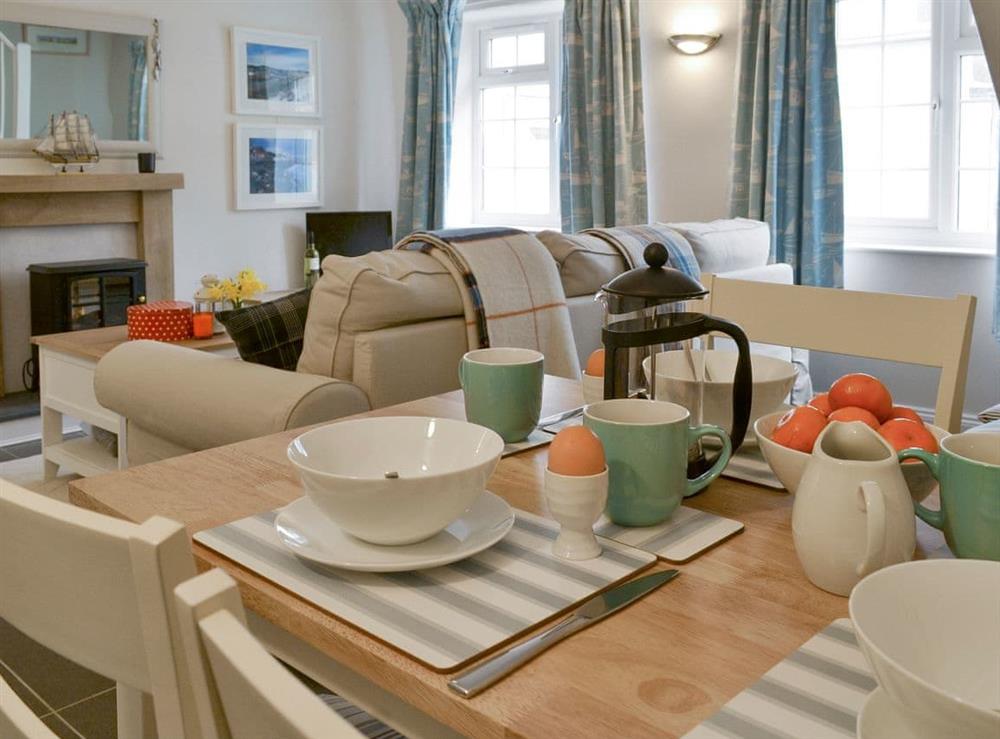 Cosy living and dining room at Teal Cottage in Instow, near Bideford, Devon, England