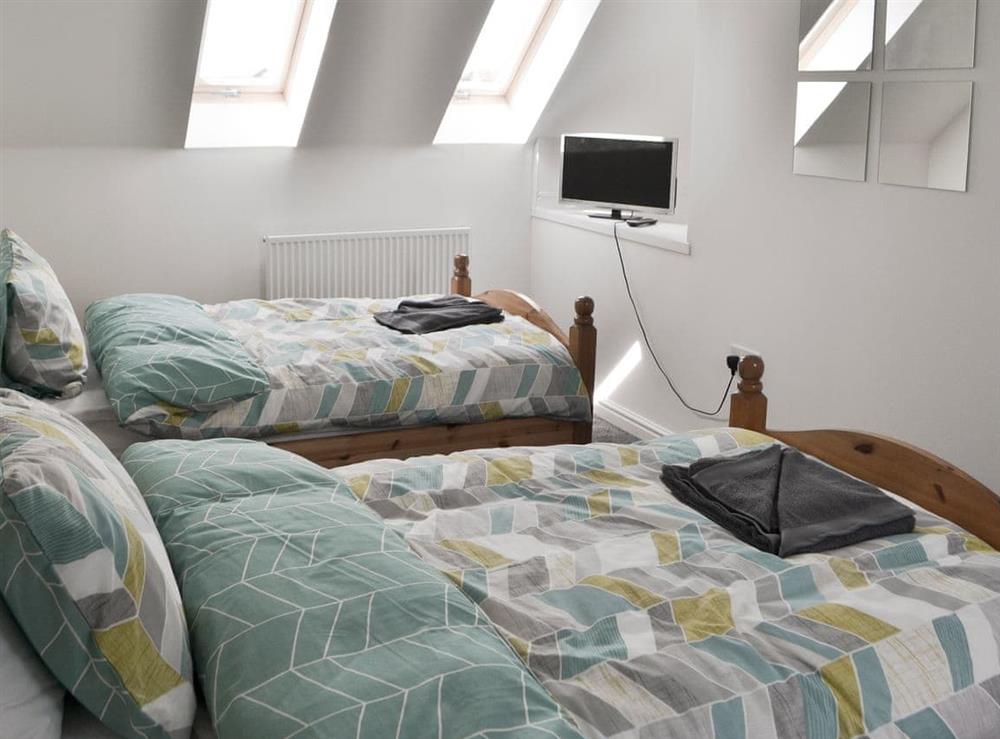 Tastefully decorated bedroom with twin beds at Teal House in Amble, Northumberland