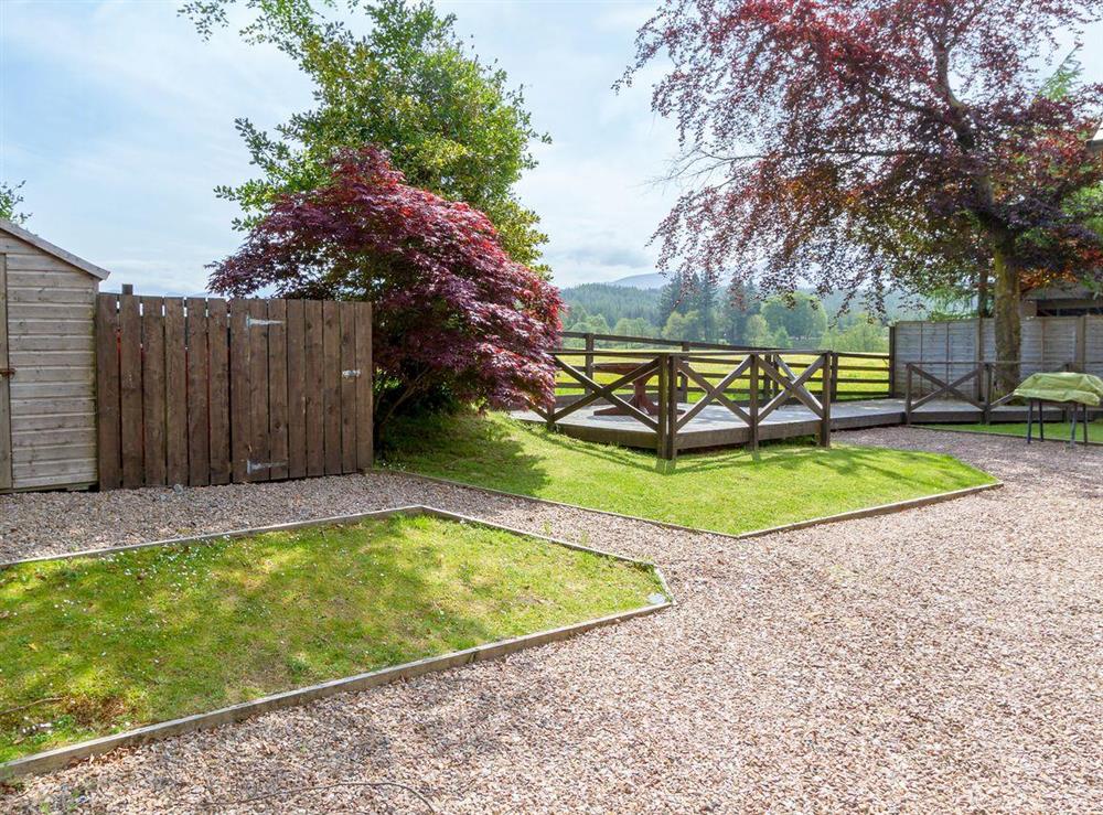 Lovely garden and grounds with decking area at Teapot Cottage in Gairlochy, Inverness-shire