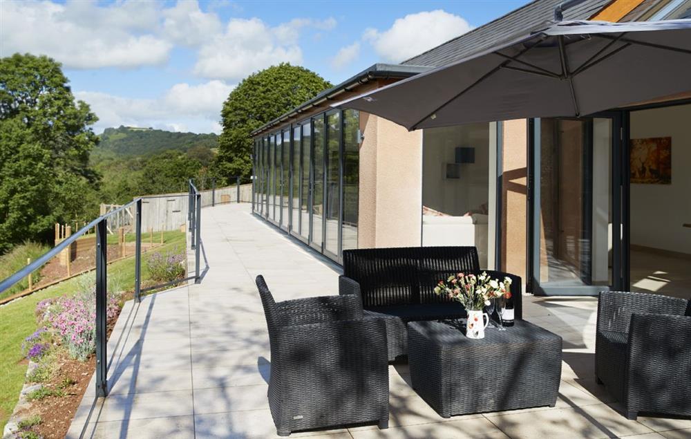 A staggering 16 metres of bi-fold doors opening out to a tiled balcony overlooking the beautiful river