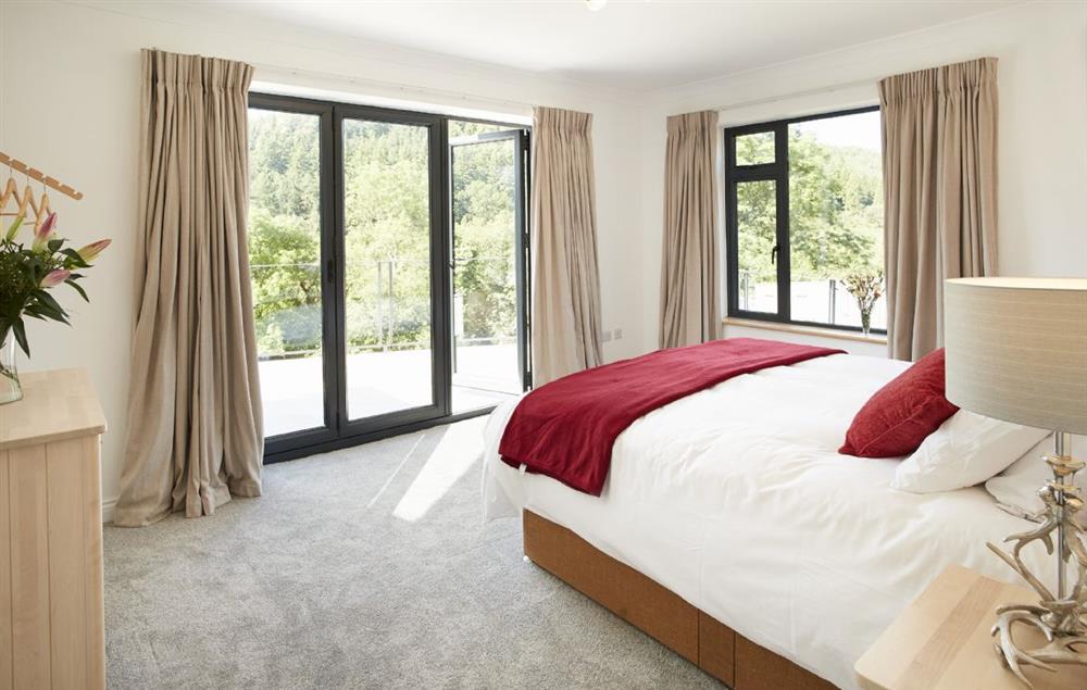 King size bedroom with en-suite shower and and bi-fold doors onto stunning views (photo 2) at Teign Vale, Drewsteignton