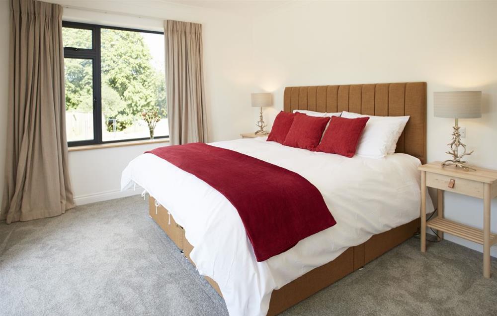 King size bedroom with en-suite shower and and bi-fold doors onto stunning views at Teign Vale, Drewsteignton