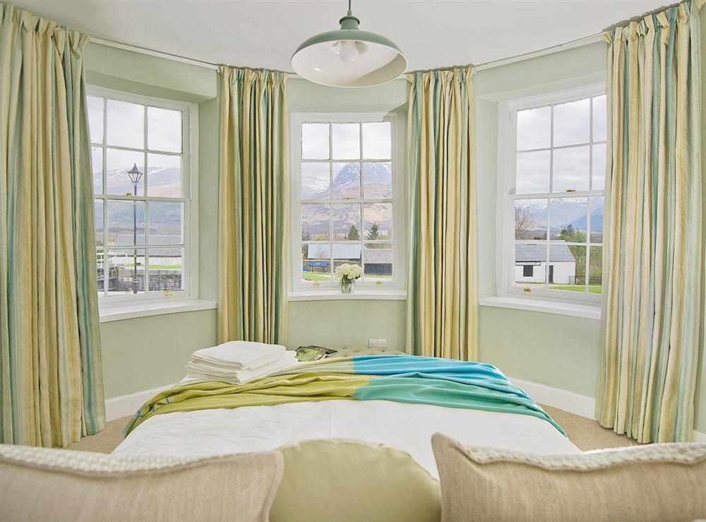 The king-sized bed affords view across the loch towards Neptune’s Staircase and Ben Nevis