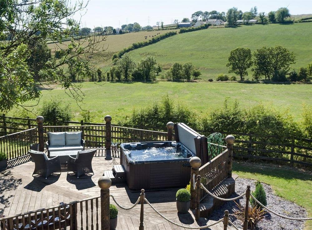 Inviting patio with sitting-out area and hot tub at Tennox Parlour in Kilbirnie, near Lochwinnoch, Ayrshire