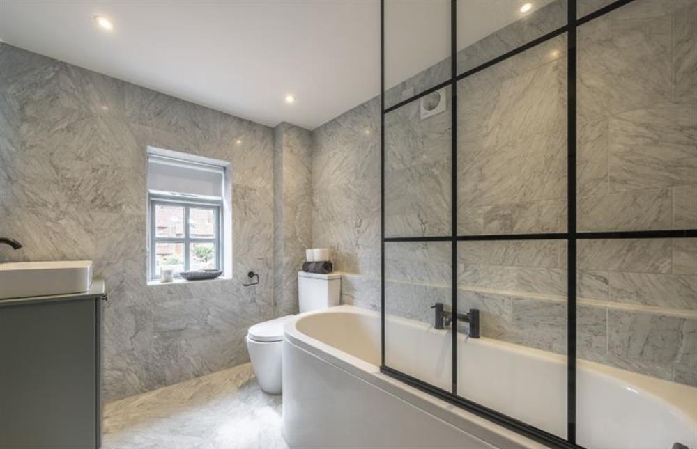 Bathroom with bath and shower over at Tern Cottage, Burnham Market near Kings Lynn