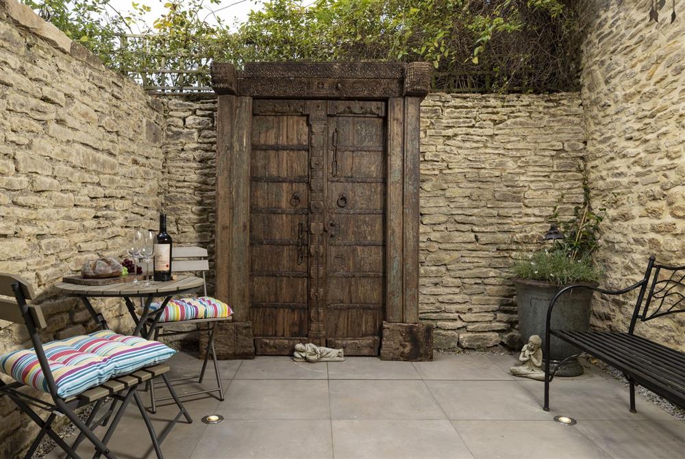 The delightful south-west courtyard with patio furniture  at Tetbury Cottage, Tetbury