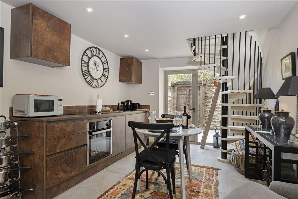 The elegant open-plan kitchen and dining area at Tetbury Cottage, Tetbury