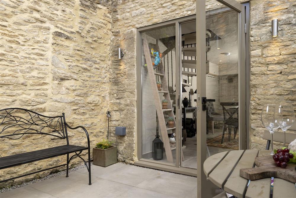 The spacious patio garden, leads directly from the kitchen and dining area at Tetbury Cottage, Tetbury