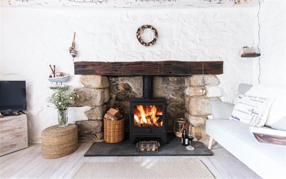 Focal fireplace and wood burner at Tewennow Cottage in Cubert