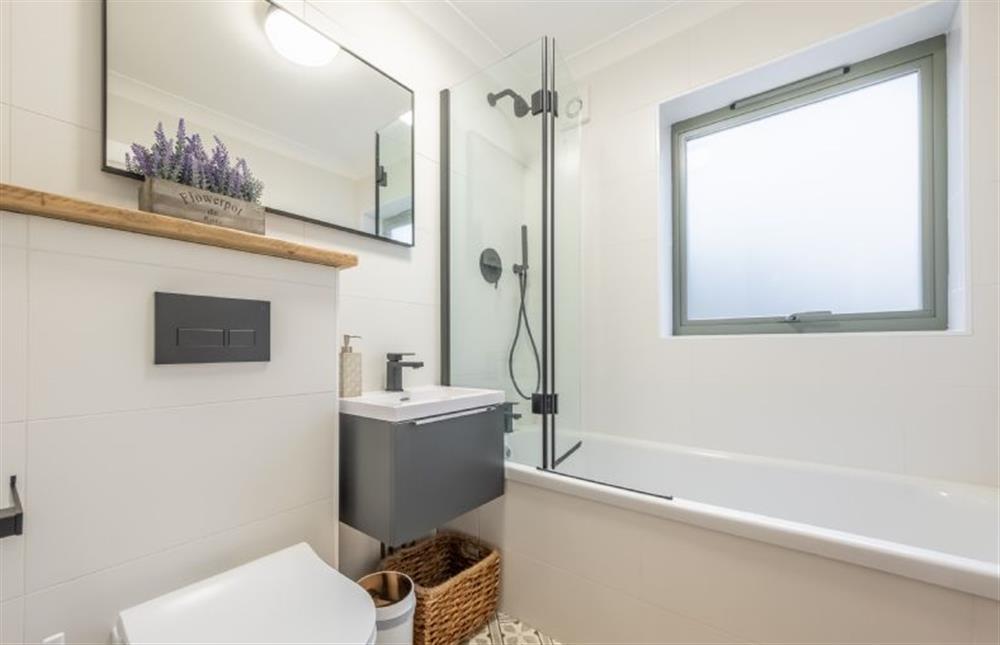 Ground floor: Bathroom with bath and shower over, wash basin and WC at Thainstone House, Brancaster near Kings Lynn