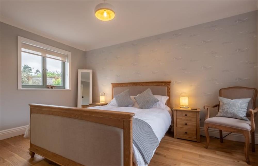 Ground floor: Master bedroom with king-size bed at Thainstone House, Brancaster near Kings Lynn