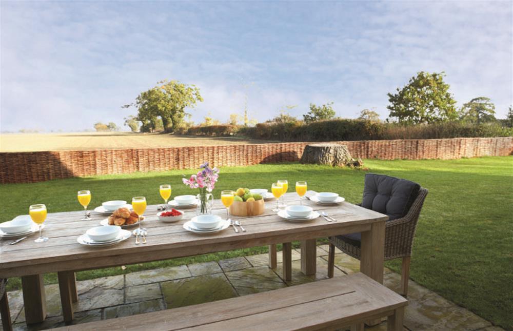 Outdoor dining with ftthe view’ at Thatch Barn, Burlingham Green near Norwich