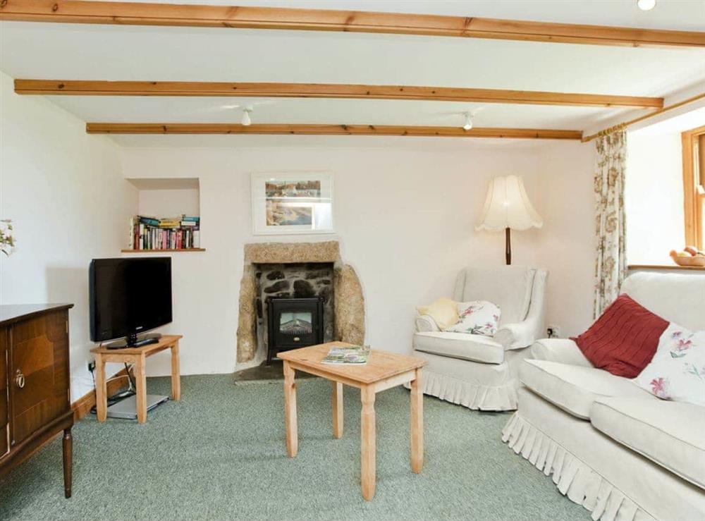 Homely living room with beams at Thatch Cottage in Rosudgeon, near Marazion, Cornwall