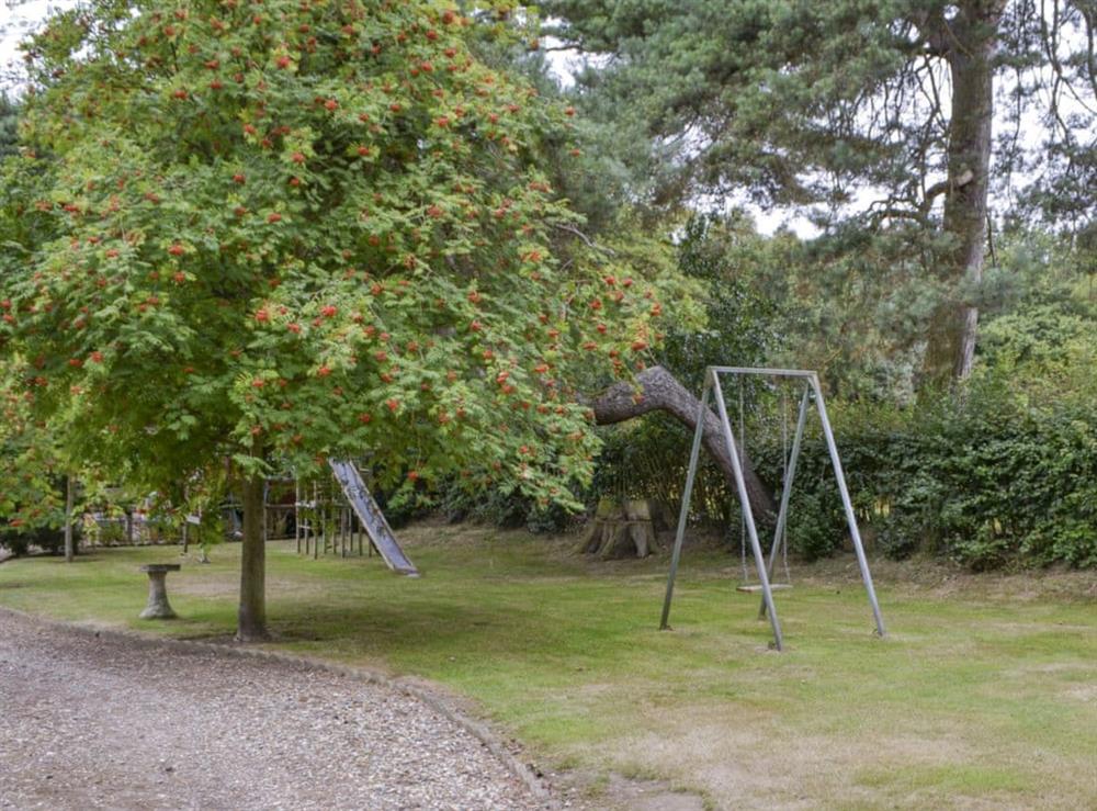 Children’s play area within garden at Thatched Cottage in Witton, near North Walsham, Norfolk