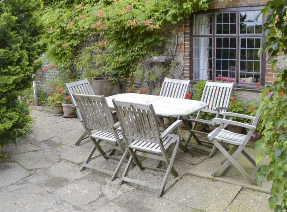 Paved patio with outdoor furniture at Thatched Cottage in Witton, near North Walsham, Norfolk